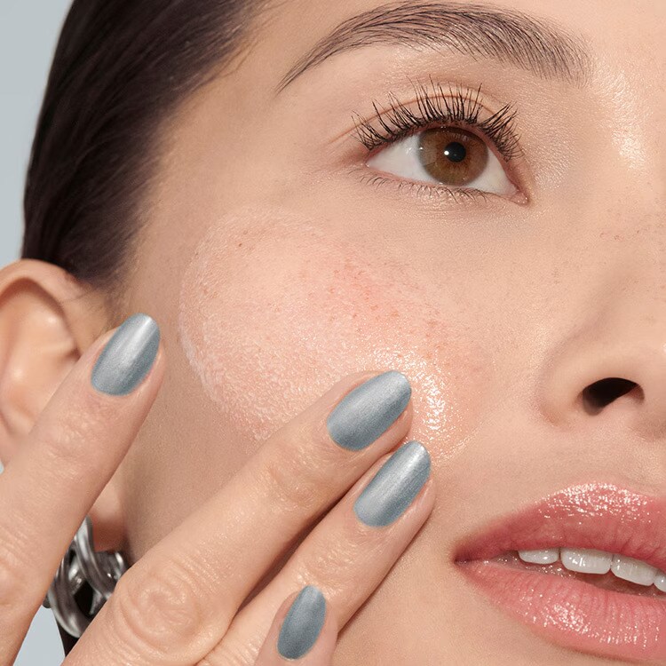 Model removing makeup with our gentle yet powerful Soothing Cleansing Oil